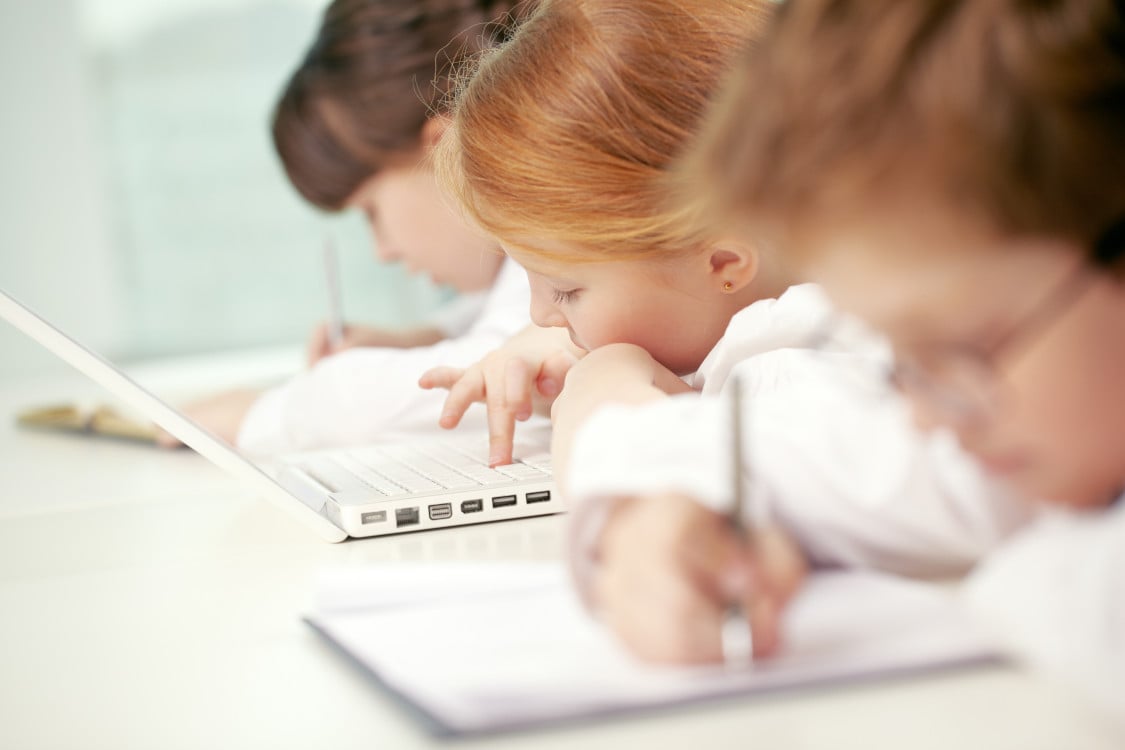 children at school taking notes